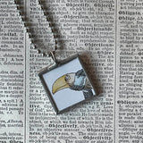 Gorey bird and man, vintage book illustrations, hand-soldered glass pendant