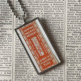 Sewing needle vintage packaging typography,  upcycled to soldered glass pendant