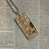 Woman flying on a blackbird and hollyhock flowers, vintage illustrations, up-cycled to soldered glass pendant