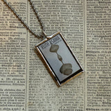 Ruth Asawa postage stamp upcycled to hand soldered glass pendant