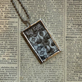 Ruth Asawa postage stamp upcycled to hand soldered glass pendant