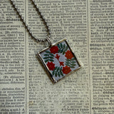 Antique quilt with flower designs, upcycled to hand-soldered glass pendant