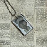 Ruth Asawa postage stamps upcycled to hand soldered glass pendant