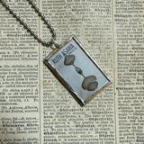 Ruth Asawa postage stamps upcycled to hand soldered glass pendant