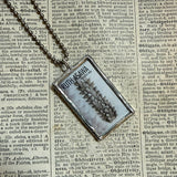 Ruth Asawa postage stamps upcycled to hand soldered glass pendant