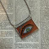 Human eye, buddhist art up-cycled to soldered glass pendant