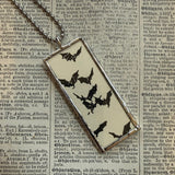 Skull and bats vintage halloween card illustrations, upcycled to hand-soldered glass pendant