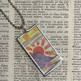 1 Rising sun, orange grove, vintage matchbox illustration, upcycled to hand-soldered glass pendant