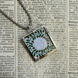 Antique quilt with flower designs, upcycled to hand-soldered glass pendant