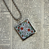 Antique quilt with flower designs, upcycled to hand-soldered glass pendant