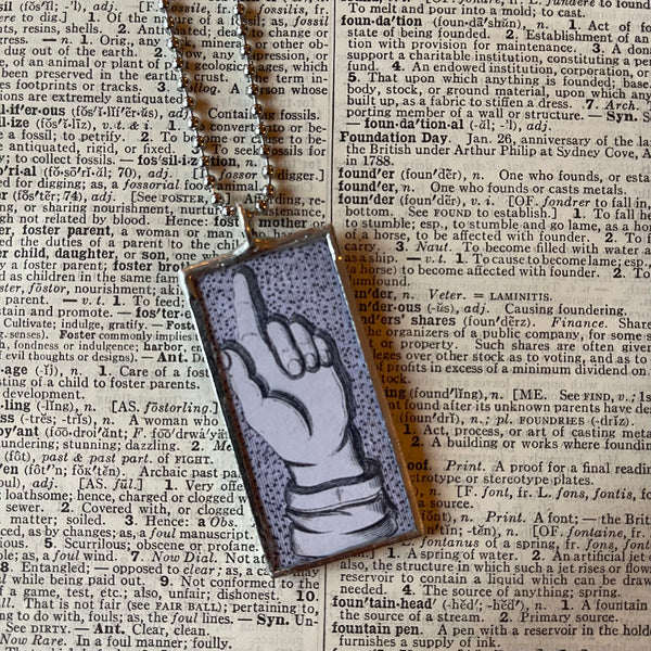 1  Pointing finger, vintage graphics, up-cycled to soldered glass pendant