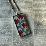 Antique quilt with flower designs, upcycled to hand-soldered glass pendant