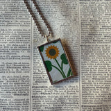 Antique quilt with horse and sunflower designs, upcycled to hand-soldered glass pendant