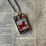 Antique quilt with horse and sunflower designs, upcycled to hand-soldered glass pendant