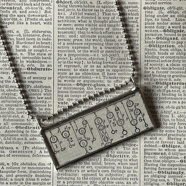 1 Pulley system , 1940s dictionary, up-cycled to hand-soldered glass pendant