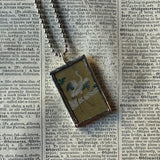 White crane and waterfall illustrations up-cycled to soldered glass pendant