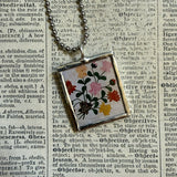 Antique quilt with flower designs, upcycled to hand-soldered glass pendant