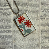 Antique quilt with flower designs, upcycled to hand-soldered glass pendant