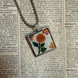 Antique quilt with flower designs, upcycled to hand-soldered glass pendant