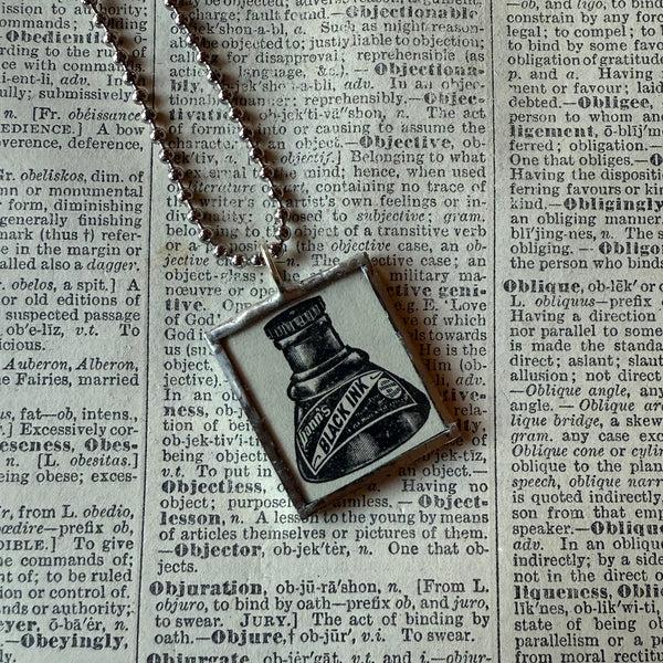 Ink bottle, advertising illustrations up-cycled to soldered glass pendant