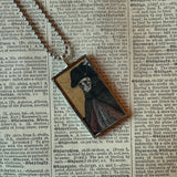 Fancy skeletons, vintage halloween illustrations, up-cycled to soldered glass pendant