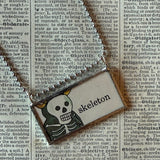 Skeleton, pumpkin vintage illustrations upcycled to hand-soldered glass pendant