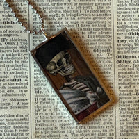 Fancy skeletons, vintage halloween illustrations, up-cycled to soldered glass pendant
