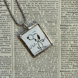 Snoopy, comic strip illustrations from vintage Peanuts book, up-cycled to hand-soldered glass pendant
