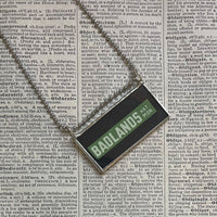 Badlands National Park travel poster, upcycled hand soldered glass pendant