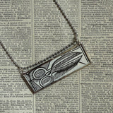 Human eye, scissors, vintage dictionary illustrations, up-cycled to soldered glass pendant