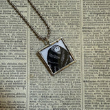 Gorey - Man in fur coat, dog Vintage book illustrations, hand-soldered glass pendant