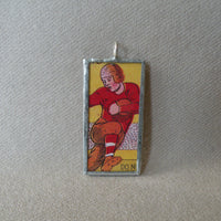 Vintage football player, vintage illustration from fireworks packaging, soldered glass pendant