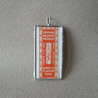 Vintage needle packaging, upcycled to hand-soldered glass pendant