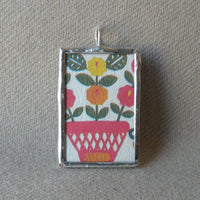Antique quilt with floral and berry designs, American folk art image upcycled to 2-sided hand soldered glass pendant